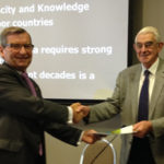 The Hon Neil Andrew presents the chair of the Crawford Fund with the report