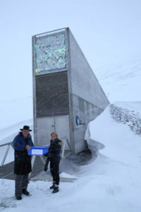 The Crop Trust’s Marie Haga and Board Member Tim Fischer carry Australian seeds into the seed vault