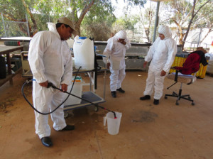 Participants Nur Nobi Mia, Selima Zahan, and Taslima Zahan calibrate sprayers